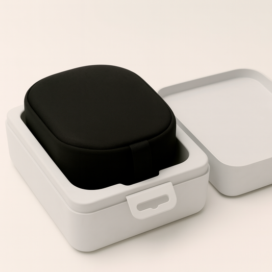 Open eco-friendly molded pulp packaging for headphones, with a black earbud case nestled inside